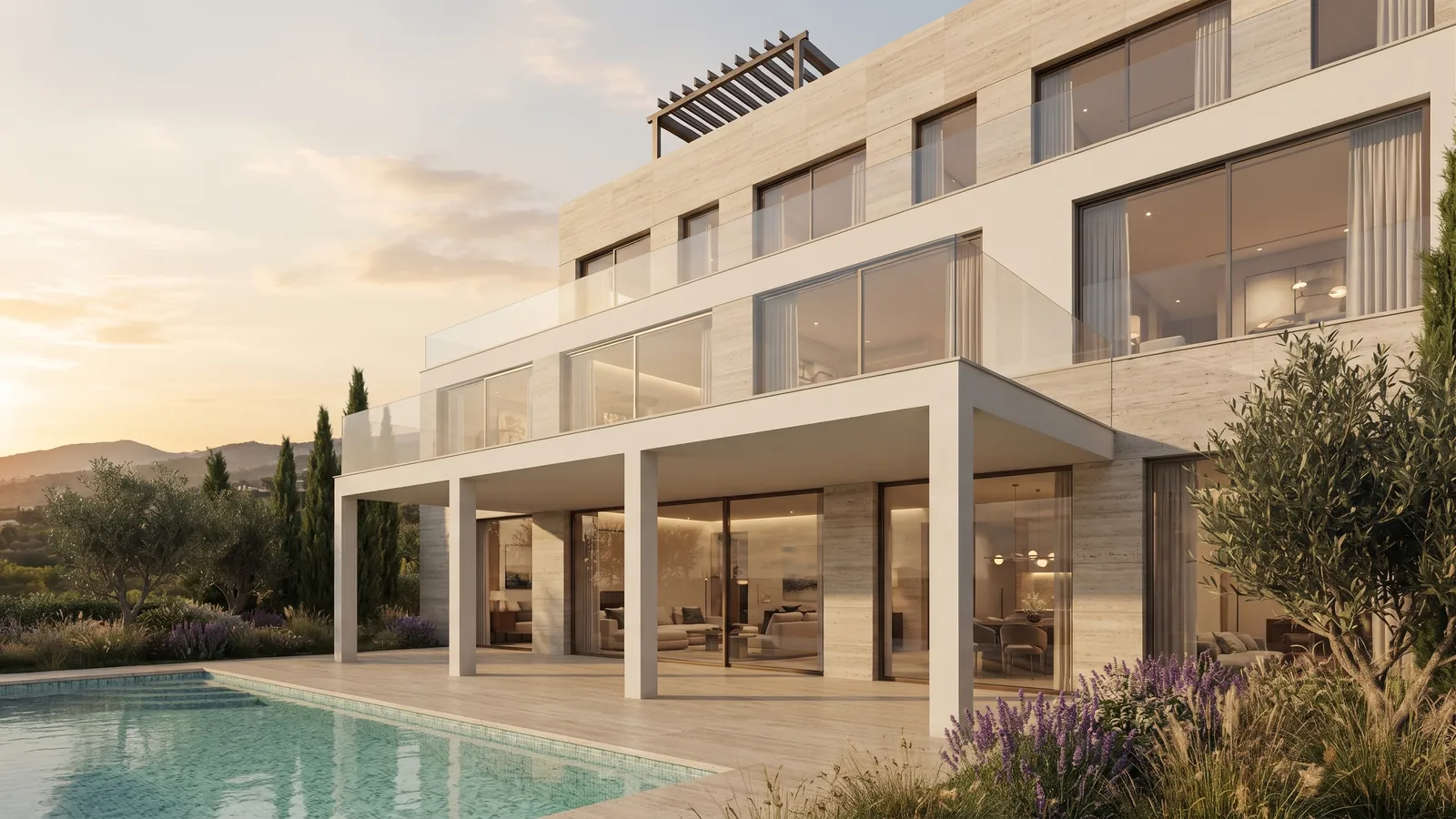 Villa with a travertine facade and a pool among olive trees at sunset